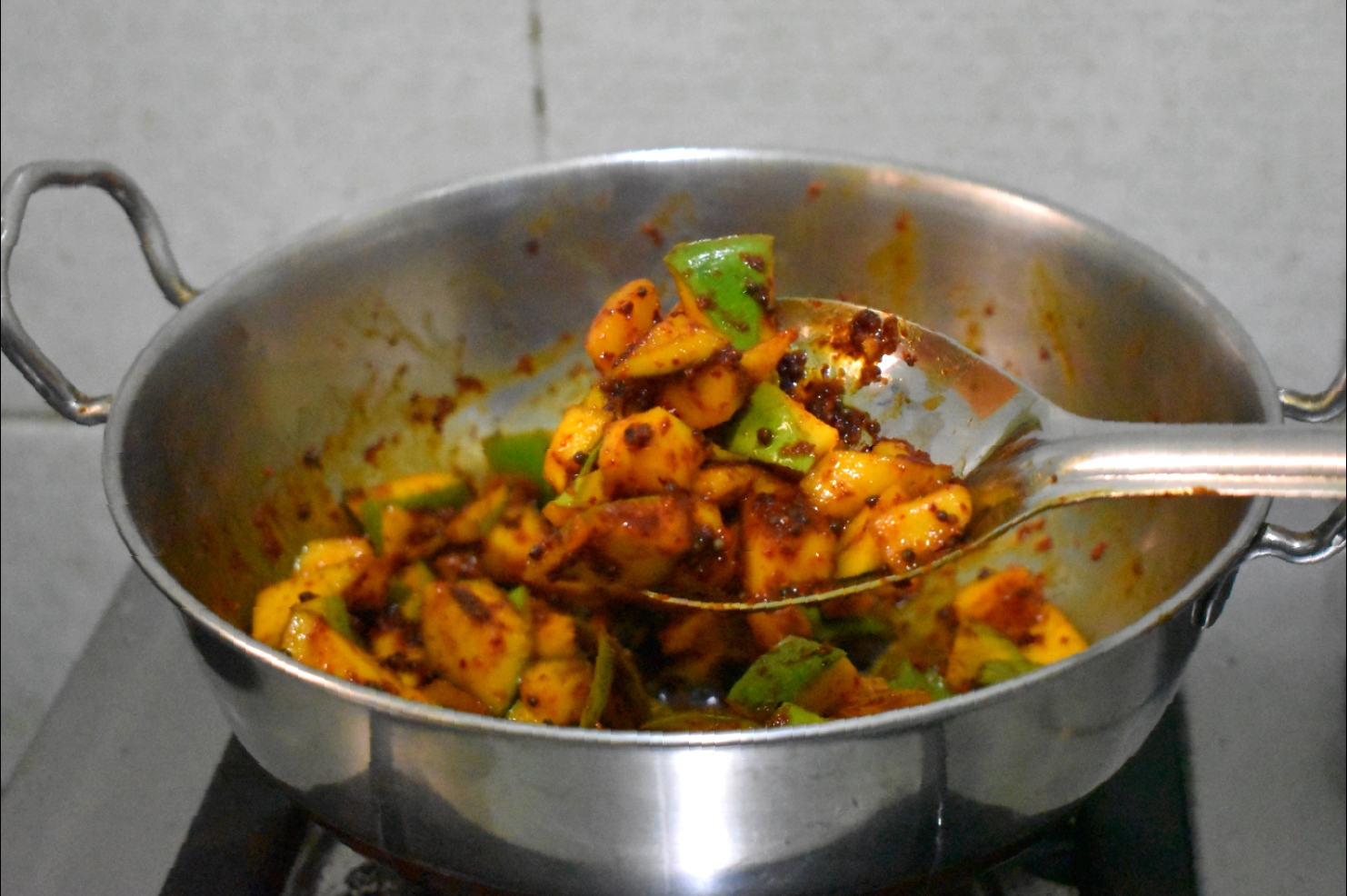 Allow the raw mango pickle to cook for a while on a medium flame